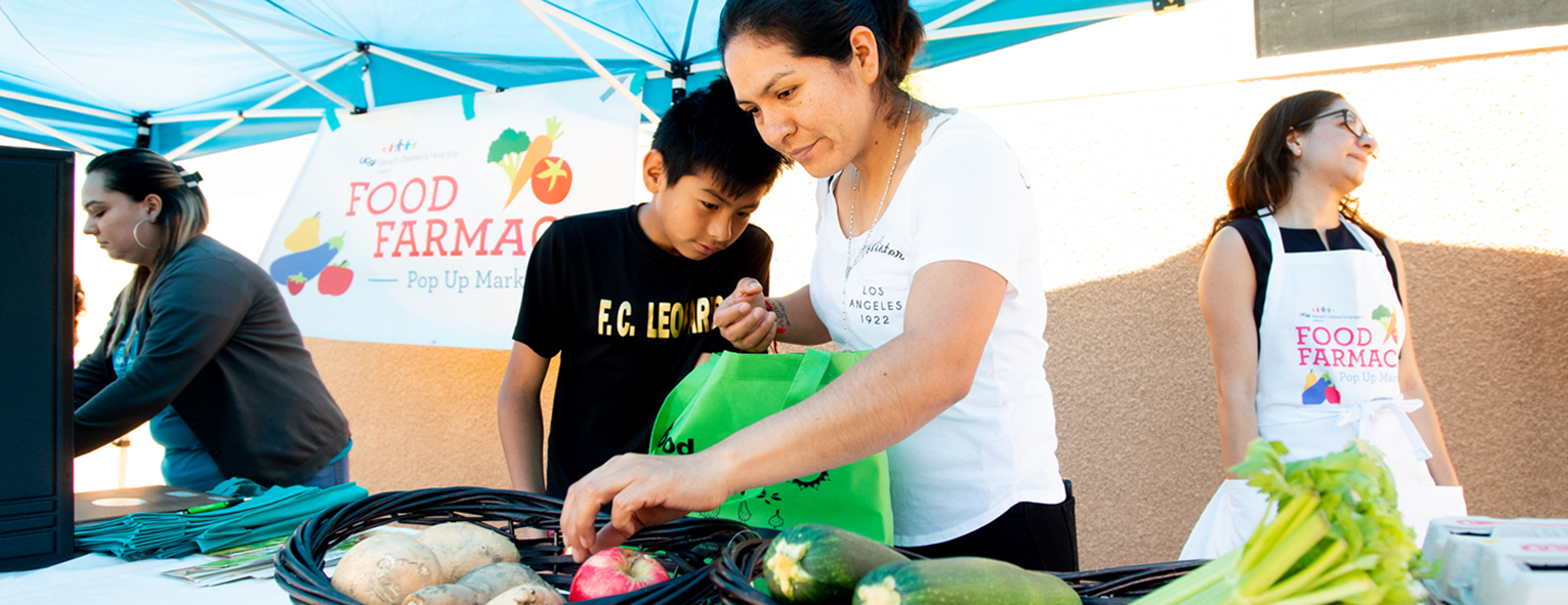 Volunteers in Food Farmacy pop-up booth, Oakland